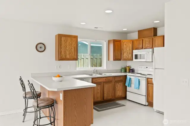 Kitchen with microwave, dishwasher, and fridge