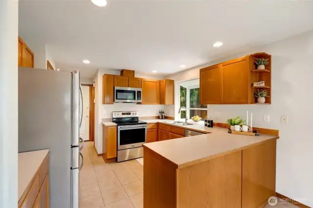 Modern, efficient kitchen with stainless appliances.