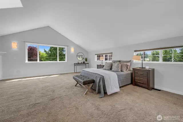 expansive Primary bedroom with sitting area and gas fireplace.