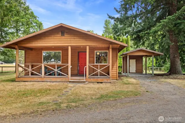 Looking at this cedar cabin with the carport and cedar-lined storage room that is just off the back door at the laundry room.