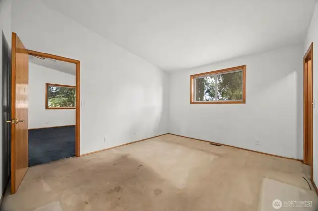 Looking toward the living room across the primary bedroom.