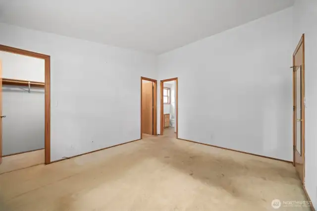Looking toward the full bath from the spacious primary bedroom.