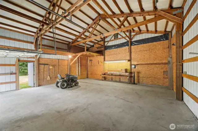 The shop is spacious and has electrical and water with a work bench and storage loft.