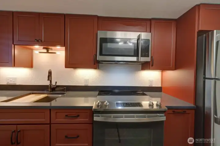 Completely remodeled kitchen with new lighting, flooring, cabinets, counter tops, appliances, fixtures and paint.
