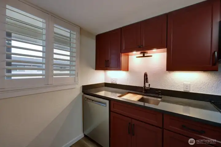 Completely remodeled kitchen with new lighting, flooring, cabinets, counter tops, appliances, fixtures and paint.