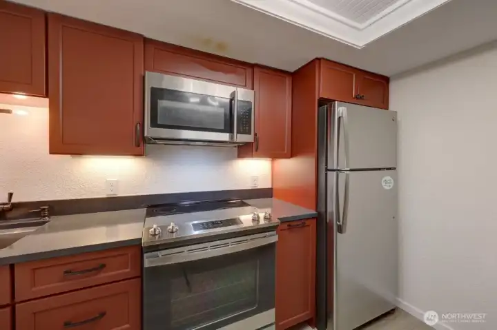 Completely remodeled kitchen with new lighting, flooring, cabinets, counter tops, appliances, fixtures and paint.