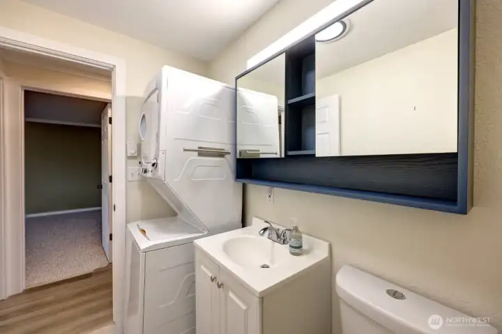 Full bath with partial remodel including new washer dryer, flooring, cabinetry, paint and lighting.