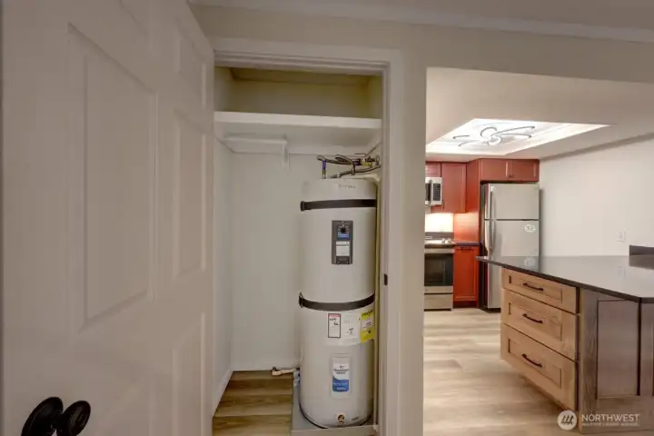 Coat closet with new water heater.
