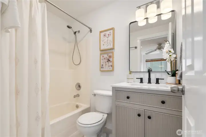 En suite bath with new vanity, light, mirror, faucet, sink