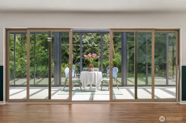 Magical brand NEW glass room off the lower level! All of those doors open up...over 300 sq ft.