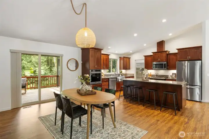 Dining area looking onto kitchen...slider leads to covered deck and stairs down to lower yard.