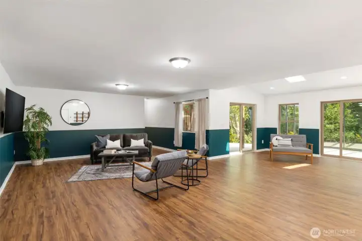 Lower level living space/great room with slider leading to glass sunroom!