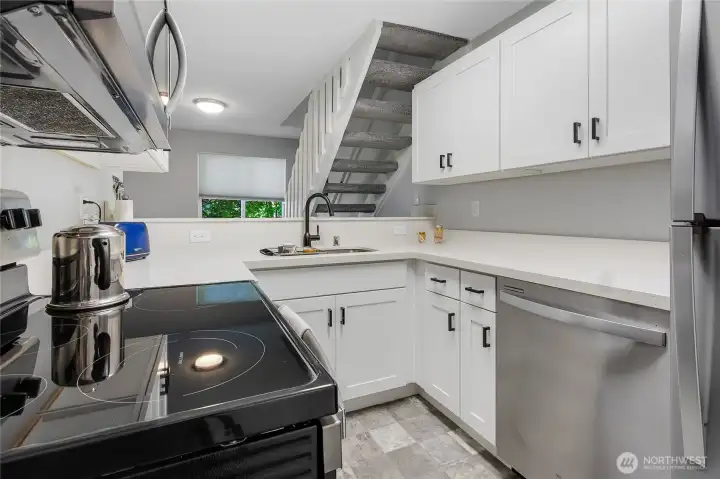 Freshly renovated kitchen with quartz counters and updated appliances