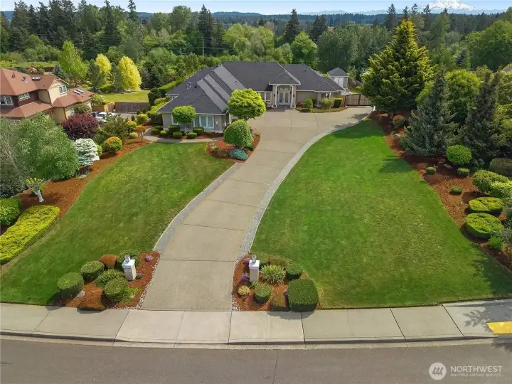 Welcome Home! Arrive to manicured grounds, a sweeping driveway, and a beautifully maintained custom rambler.
