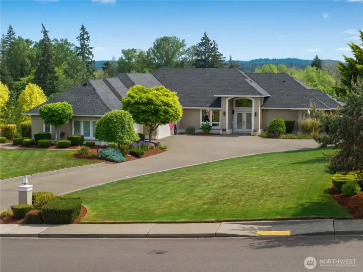 The property enjoys a beautiful setting with Mt. Rainier visible beyond the trees.