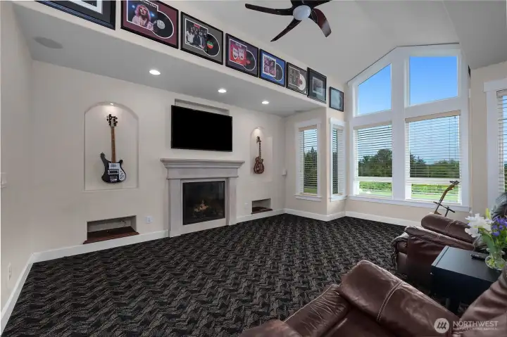 The living room features a fireplace, high ceilings, and abundant natural light.