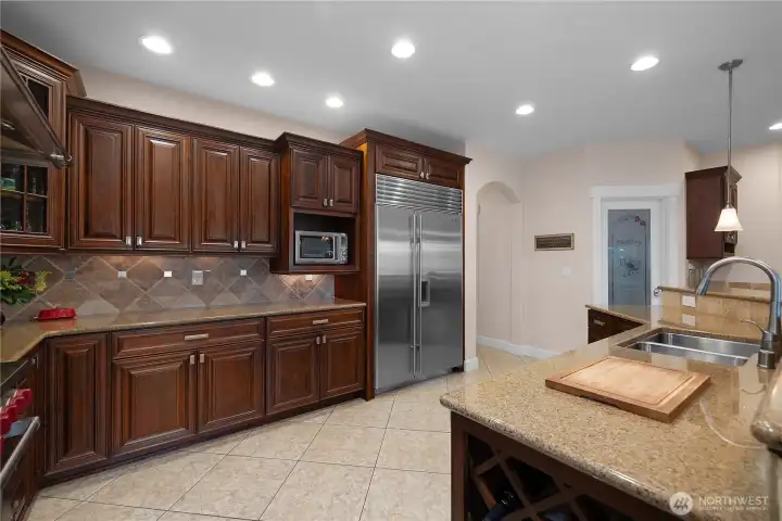 Keep everything organized with abundant cabinetry, granite counters, and nearby pantry access.