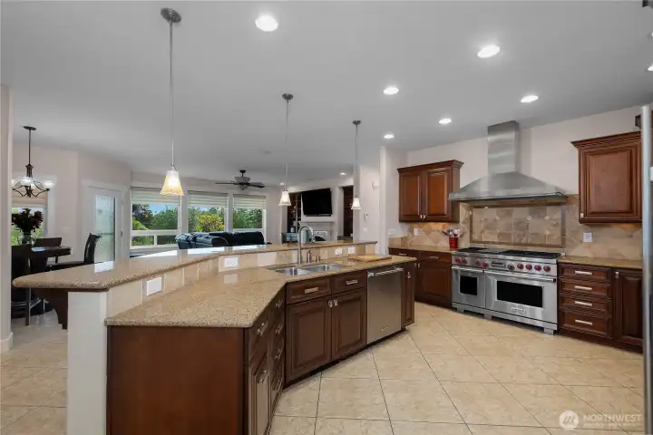 The kitchen features generous counter seating and a comfortable connection to the living area.