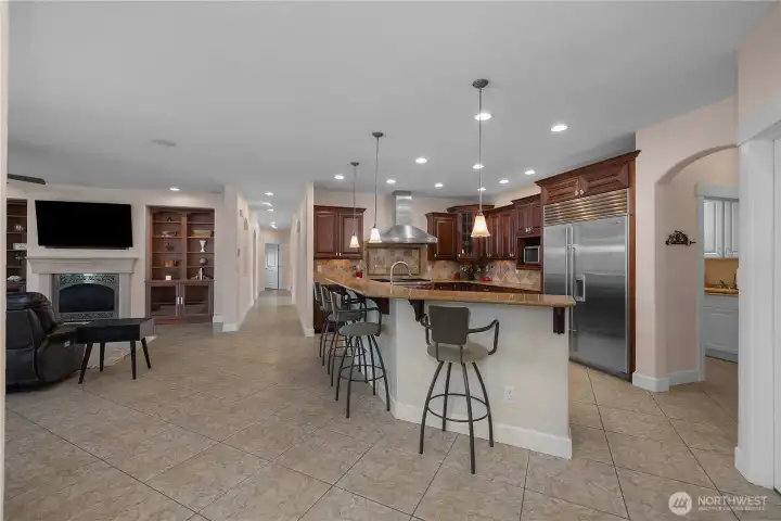 Entertain with ease from the open kitchen, large counter seating, and adjoining living area.