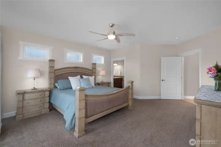 Enjoy a roomy primary suite with ensuite access, high windows, and a private feel.