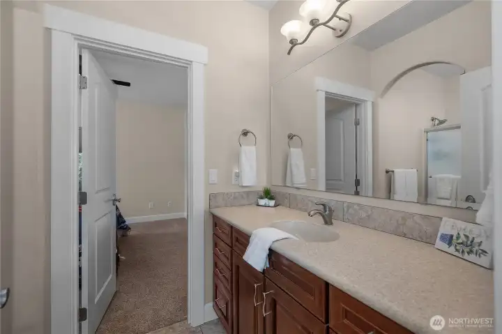 Jack and Jill Bath! Enjoy a spacious bath vanity with warm cabinetry, wide counter space, and clean finishes.