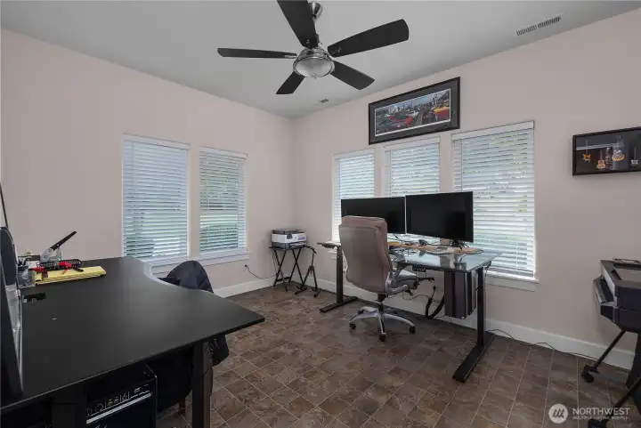 Work from home in the finished office off the garage with space for multiple desks and equipment. Attached 3/4 bath for guest quarters potential.