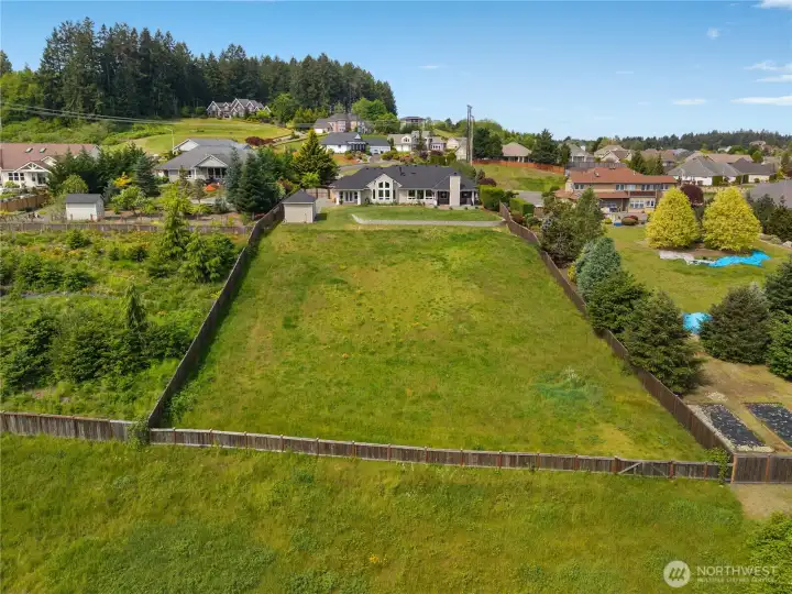 Enjoy a large fenced backyard with room to garden, play, relax, or entertain.
