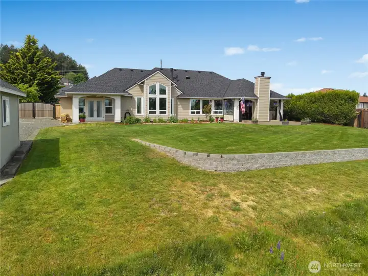 The rear yard is terraced for usable outdoor space and a polished landscape design.