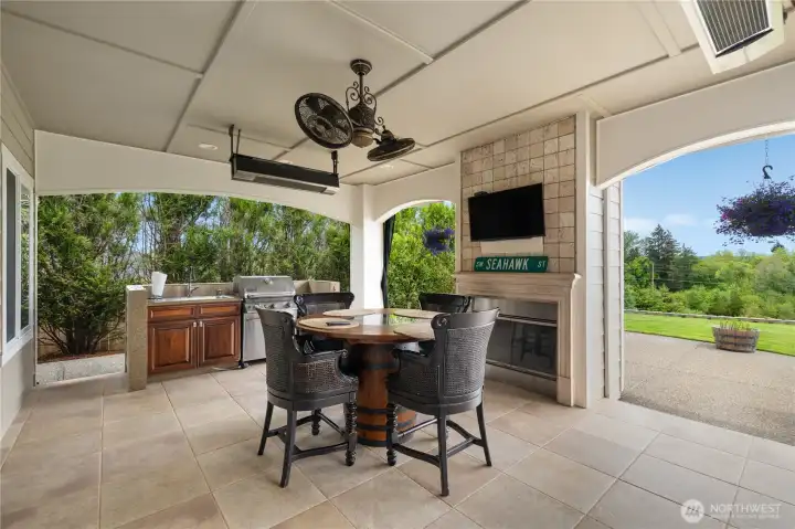 Entertain year-round on the covered patio with fireplace, BBQ kitchenette, and open views.