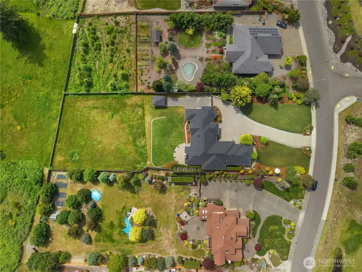 The aerial view highlights the home’s lot layout, outdoor spaces, and generous parking.