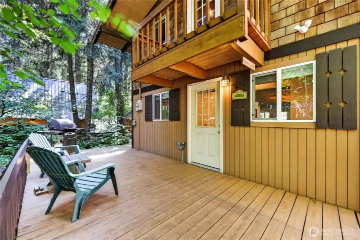 Spacious front deck providing outdoor living space surrounded by established trees. Spacious front deck providing outdoor living space surrounded by established trees.
