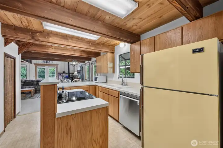Kitchen with abundant cabinetry, laminate countertops, and open sightlines to the living areas. Kitchen with abundant cabinetry, laminate countertops, and open sightlines to the living areas.