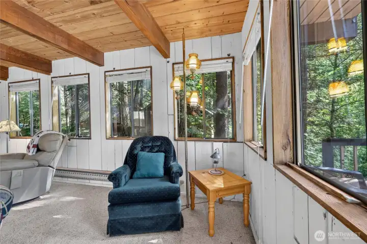 Sitting area overlooking the surrounding evergreen landscape through oversized windows. Sitting area overlooking the surrounding evergreen landscape through oversized windows.