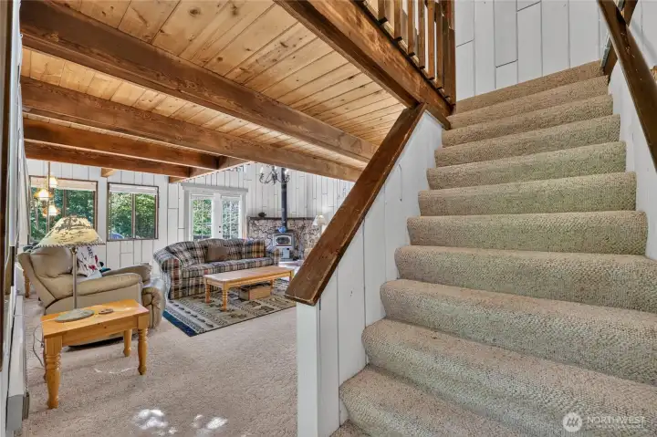 Staircase leading to the upper loft and primary suite. Staircase leading to the upper loft and primary suite.