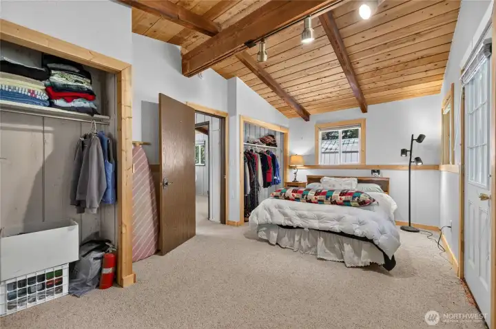 Alternate view of the primary bedroom highlighting generous floor space and closet storage. Alternate view of the primary bedroom highlighting generous floor space and closet storage.