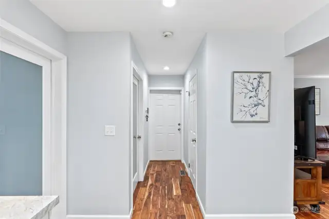 Hallway off the kitchen with large walk-in pantry, bath, laundry room and garage.