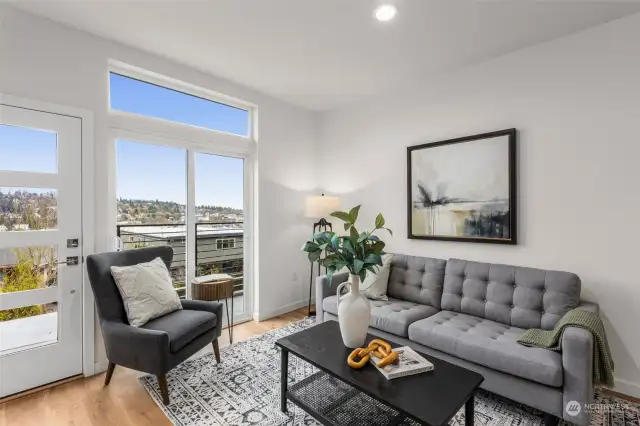 Bask in the sunlight in this bright living room featuring expansive windows. Enjoy stunning views of the Bay while sipping your morning coffee or unwinding after a long day.