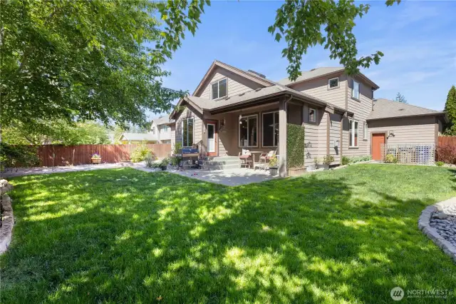Another view of the fully fenced backyard and covered patio!