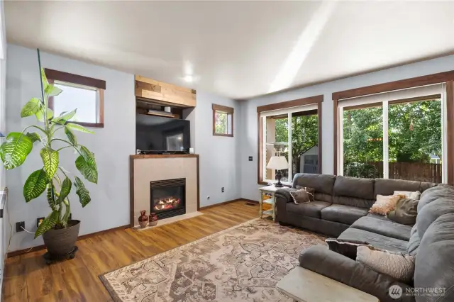 Family Room with Gas Fireplace featuring brand new tile surround and solid wood trim!