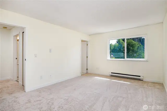 Primary bedroom is generously sized with brand new carpet.