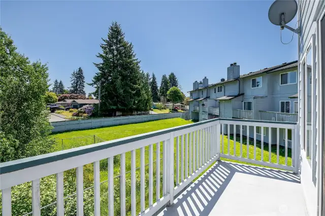 East facing balcony overlooking green space.