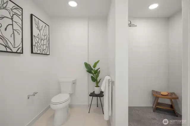Bathroom features an ADA compliant ceramic tile shower