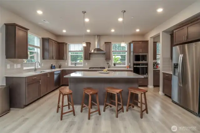Beautiful kitchen with gas cooktop and large island.