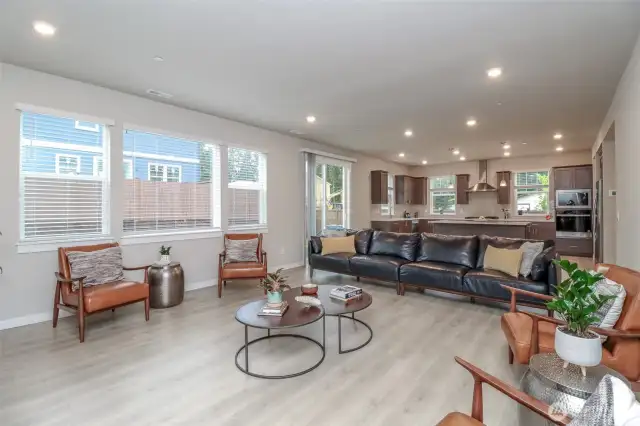 Great room off the kitchen with large windows.