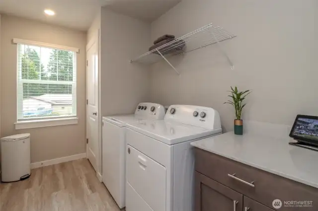 Upstairs laundry with extra storage.