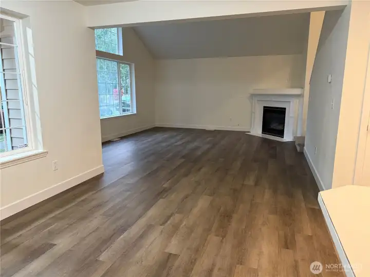 View of living room from dining area looking at gas fireplace