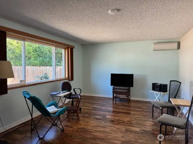 Beautiful wood-look laminate flooring greet you in the large living room.