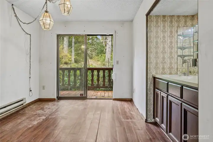 Just off of living room and kitchen find this Wet Bar for entertaining (or craft room?) with slider to lush backyard.