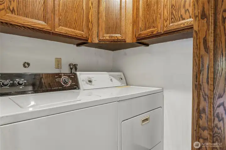 Utility room--water heater at right concealed by cabinet door.