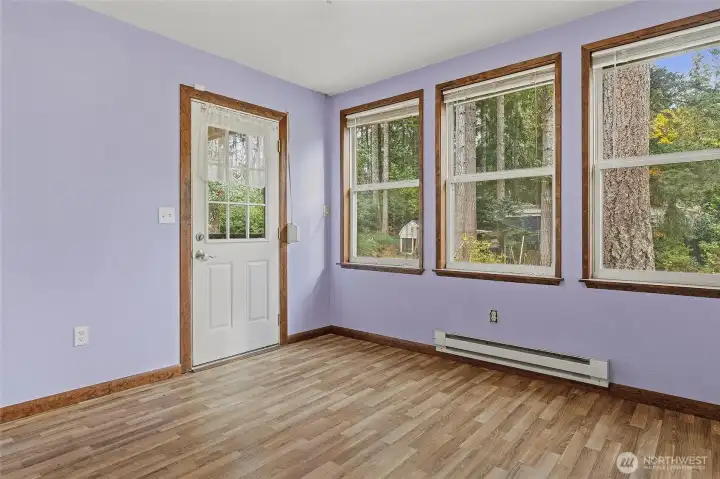 Airy and light room that leads to the back deck. Play room? Games? Sewing? Former resident had a free-standing closet in here and used this as her main floor bedroom.